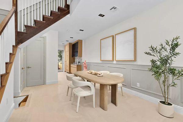 Dining area with fresh paint and flooring. Wainscotting. Custom shelves.