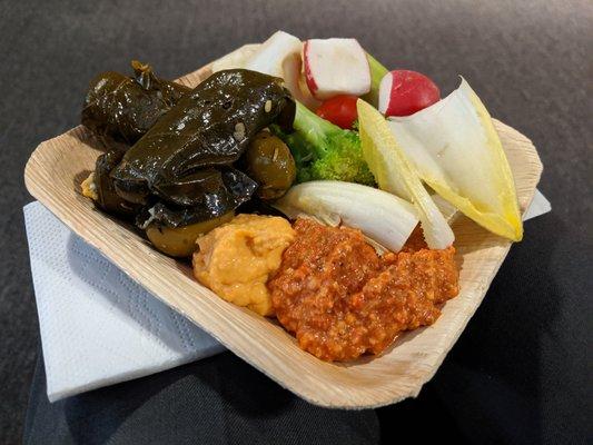 Wedding reception cocktail hour bites. Stuffed grape leaves and green olives, muhammara (red pepper and walnut spread), hummus, and more.