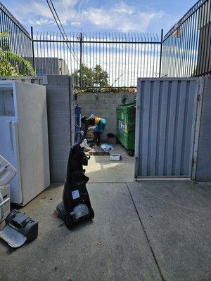 Homeless woman digging in the dumpsters and leaving the mess on the ground. Taken 9/15/24..