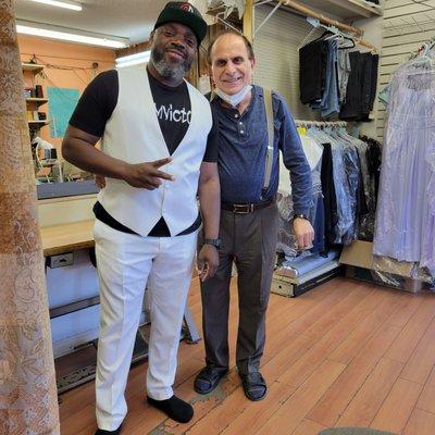 My Fiancee and Stephano. Stephano made the vest and pants fit my man perfect!! My wedding dress is next!