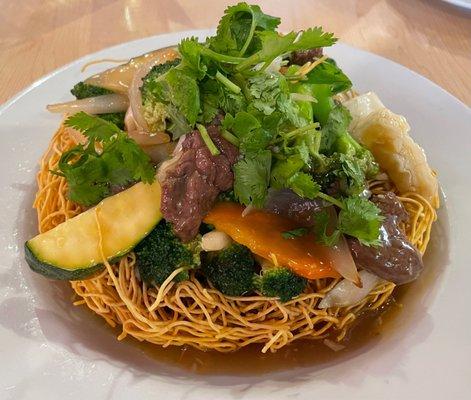 Shaking Beef Stir-Fry - filet mignon, garlic, broccoli, carrots, sweet onions, zucchini and cabbage on crispy egg noodles