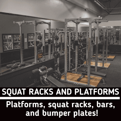 Squat racks and platforms in the back of the gym