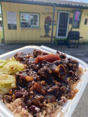 Oxtail Dinner served with rice and peas side of cabbage