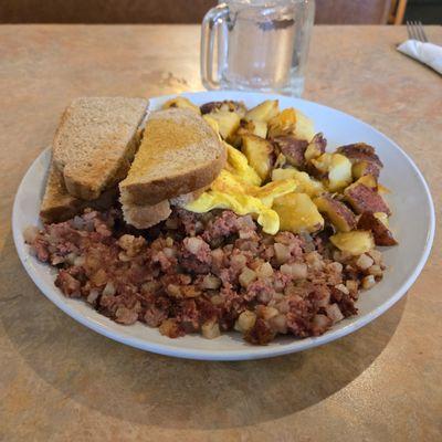 Eggs, bread, potatoes, and corned beef hash