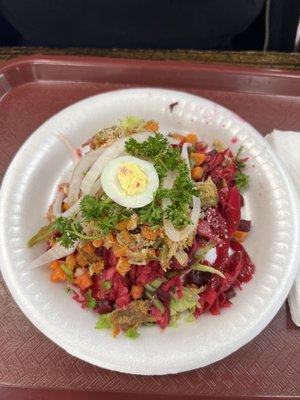 guatemalan enchiladas (essentially a tostada topped off with meat parsley beets hard boiled egg onion bedded on an iceberg lettuce)