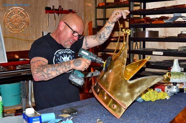 Kings Of Canna logo crown made with 32oz dark brass and copper accents. This is the owner of the shop doing some extra polishing work.