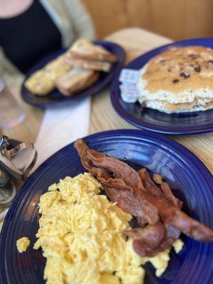 Chocolate chip pancakes, eggs, bacon, etc.