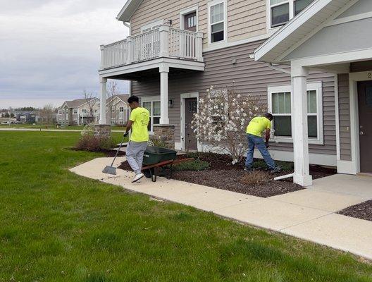 T.C. Landscaping team adding fresh mulch to new properties