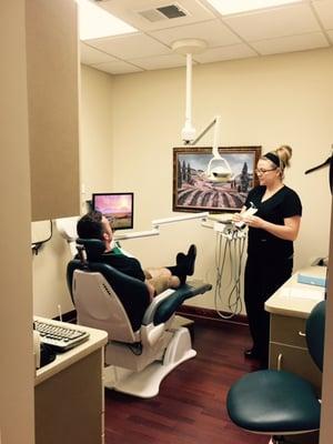 Lisa, our hygienist, prepares a patient for a cleaning.