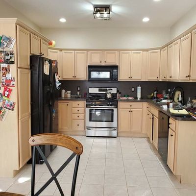 Painting the cabinets from brown to white.