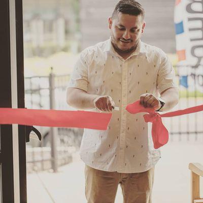 The barber shops owner cutting the ribbon marking the offical shop as a new establishment in Westfield Indiana.