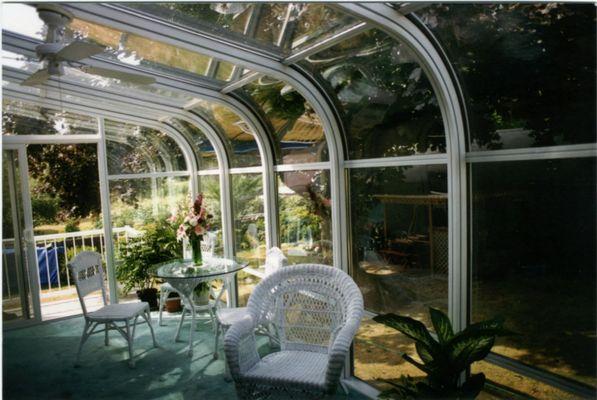 Curved glass traditional style sunroom.