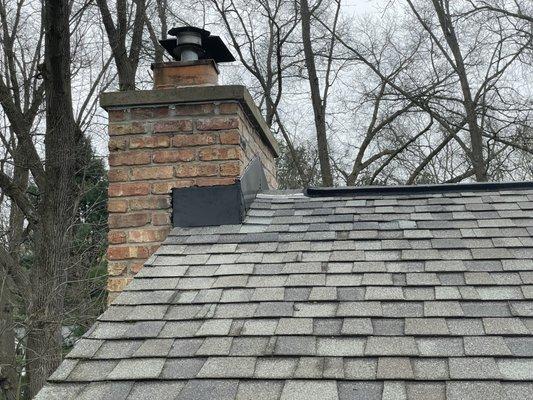 Replaced crown washing, top levels of masonry, flashing, and shingles.