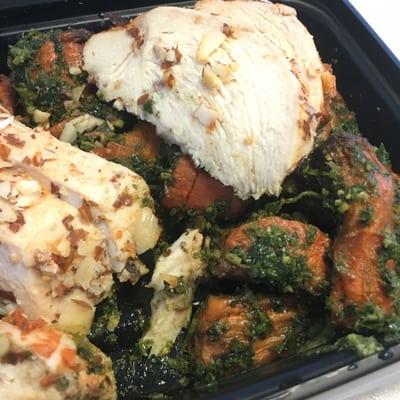 Almond crusted chicken with roasted carrots in a kale pesto.