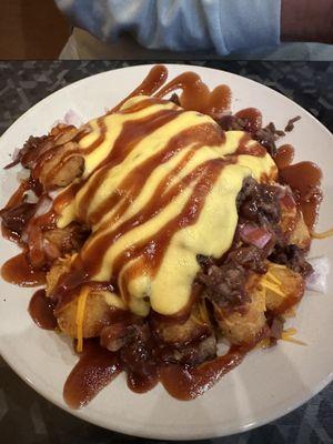 Tater tots with chicken-cheese, and bbq sauce.