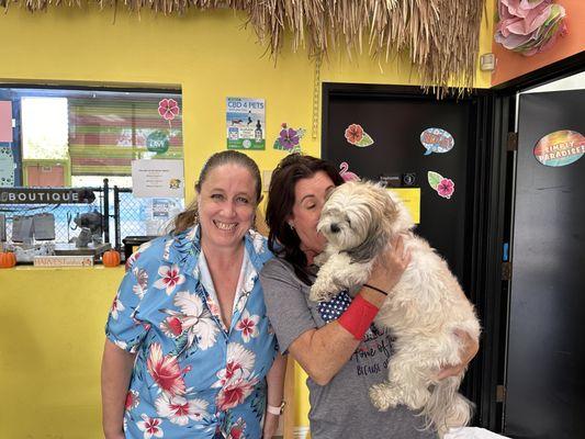 Puck with two members of team Beach Dog Fun! This is truly one of the best doggy daycares I have found!