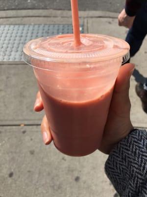 Morning smoothie with oatmeal, banana, strawberries, and orange juice.