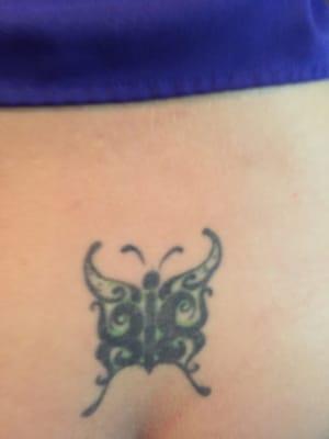 Cover up tramp stamp. From marijuana leaf to freehand butterfly.