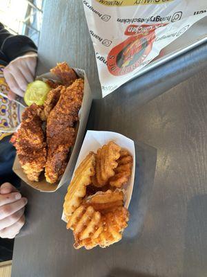 Hot chicken tenders and waffle fries