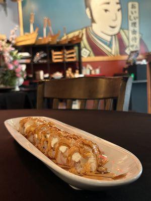 Monster roll - Shrimp tempura, crab stick, cream cheese topped with tempura shavings, eel sauce and seafood sauce