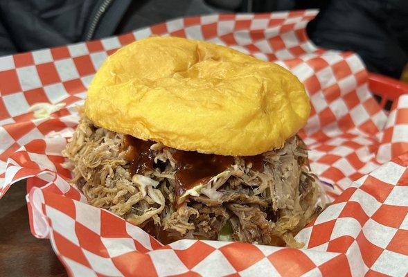 Pulled pork sandwich, piled high with tender meat