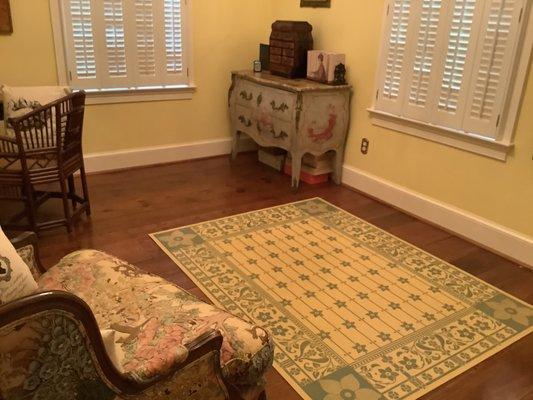 Custom floorcloth protecting the floor in this lovely sitting room.