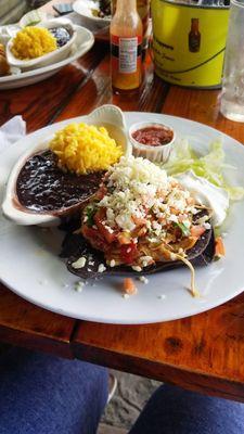 Chicken tostada with beans and yellow rice.