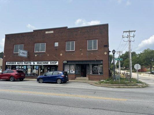 Coffee shop is on the right of this photo. They have some outdoor seating to the right of the building too.