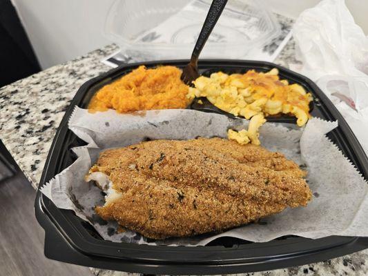 Savoring Bosa fish with creamy mac and cheese and sweet potato pie yams.