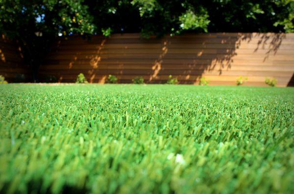 S blade 90 artificial grass with wood and drip irrigation.