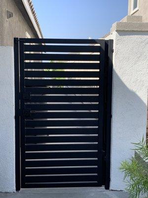 Modern Black metal side gate with lock and powder coating.