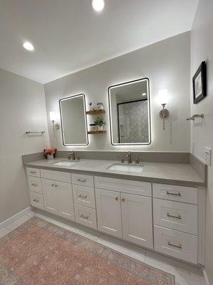 Bathroom remodel with mirror lights on.