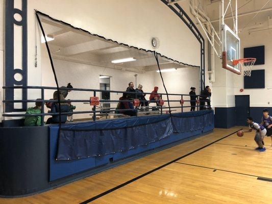 The new net protecting the stands is a bit of overkill for kids basketball games. It really takes away from the viewing of the game.....