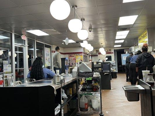 Lazy ass waffle house worker sitting in customer seating.