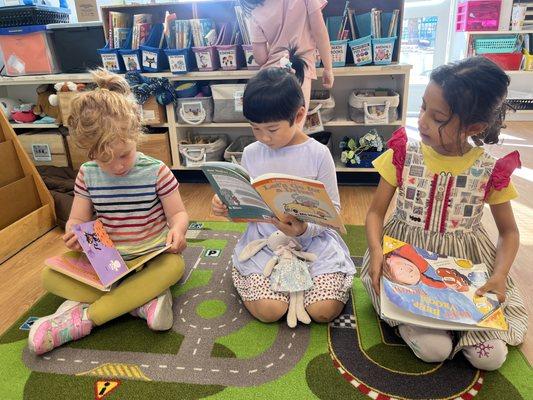 Kindergarten students reading books