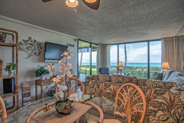 Unit 114 at The Mahan dining room table looking into the living room, lanai and ocean.