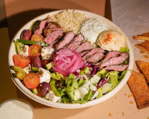 USDA Prime rib-eye. Healthy Greek rice, green salad, Greek salad, hummus, dips and feta. pickled onions.