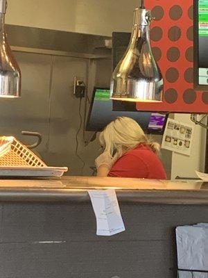 The manager cooking without a hair et, while on the phone. Very unsanitary