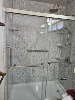 a rain shower with hand-held too. Two grab bars and 4 shelves