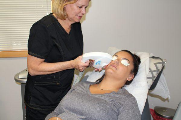 RN Sue using an IPL laser to improve skin tone and texture.