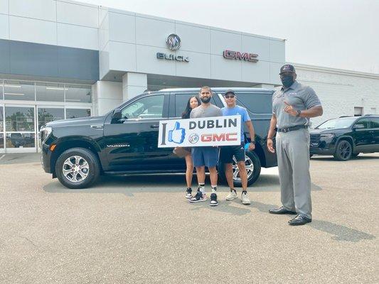 Tavis helping another family into a beautiful 2021 Yukon!