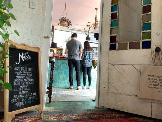 Shares a space with Sukha Yoga. Looking from the yoga studio into the coffee bar