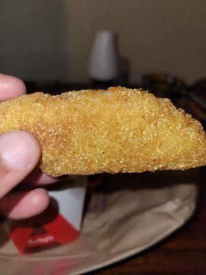 A close up view of the corn breaded fish.