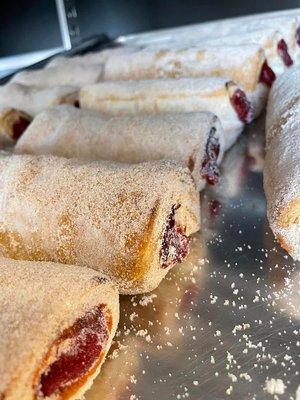 Pastry with a strawberry filling, dusted in sugar