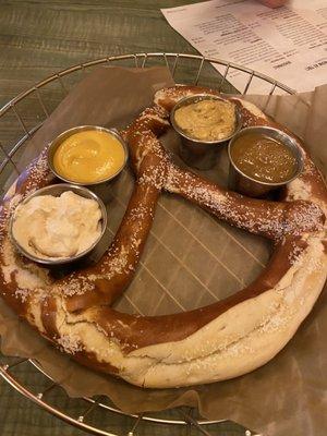 Big pretzel with beer cheese, maple mustard, regular mustard and spicy mustard.