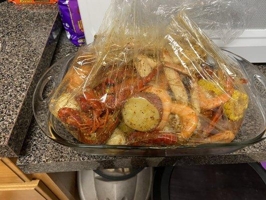 Crab legs, lobster tail, crawfish and shrimp, with some corn