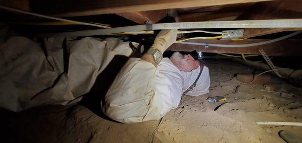 One of our best Master Inspectors and General Contractor Tom Dundorf Inspecting a crawlspace underneath the foundation.