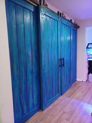 Custom aqua blue / black shaded barn doors 2" x 1/4" steel straps double railed these doors are custom retrofitted.