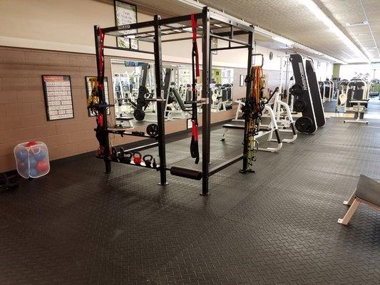 Steel body T rack that can be used as a squat rack and we have some suspension trainers attached to it as well as some kettlebells.