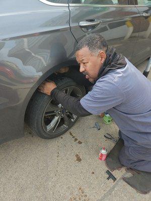 Ralph repairing the tire and then checking the air pressure in all the tires!